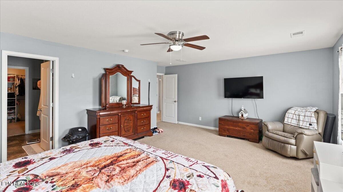 1816 River Poppy Road Mascot, TN 37806 - Photo 29 of 52 a bedroom with a bed and a flat screen tv