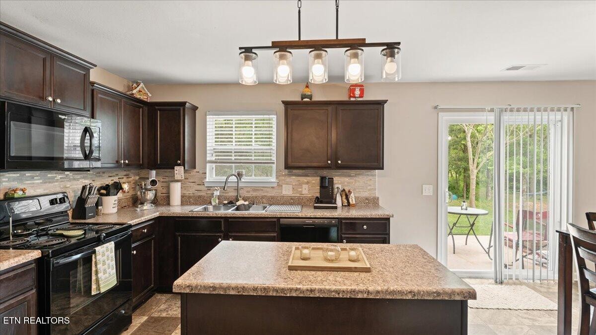 1816 River Poppy Road Mascot, TN 37806 - Photo 3 of 52 a kitchen with stainless steel appliances granite countertop a sink stove and refrigerator