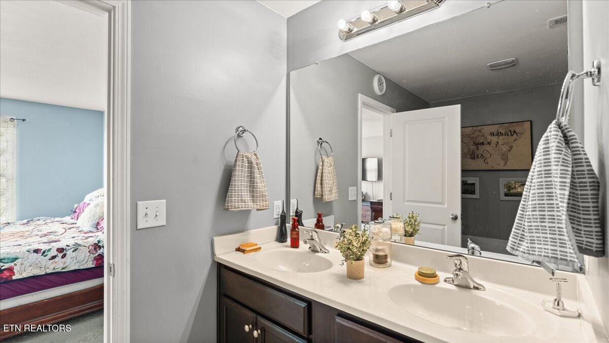 1816 River Poppy Road Mascot, TN 37806 - Photo 31 of 52 a bathroom with a sink double vanity and a mirror