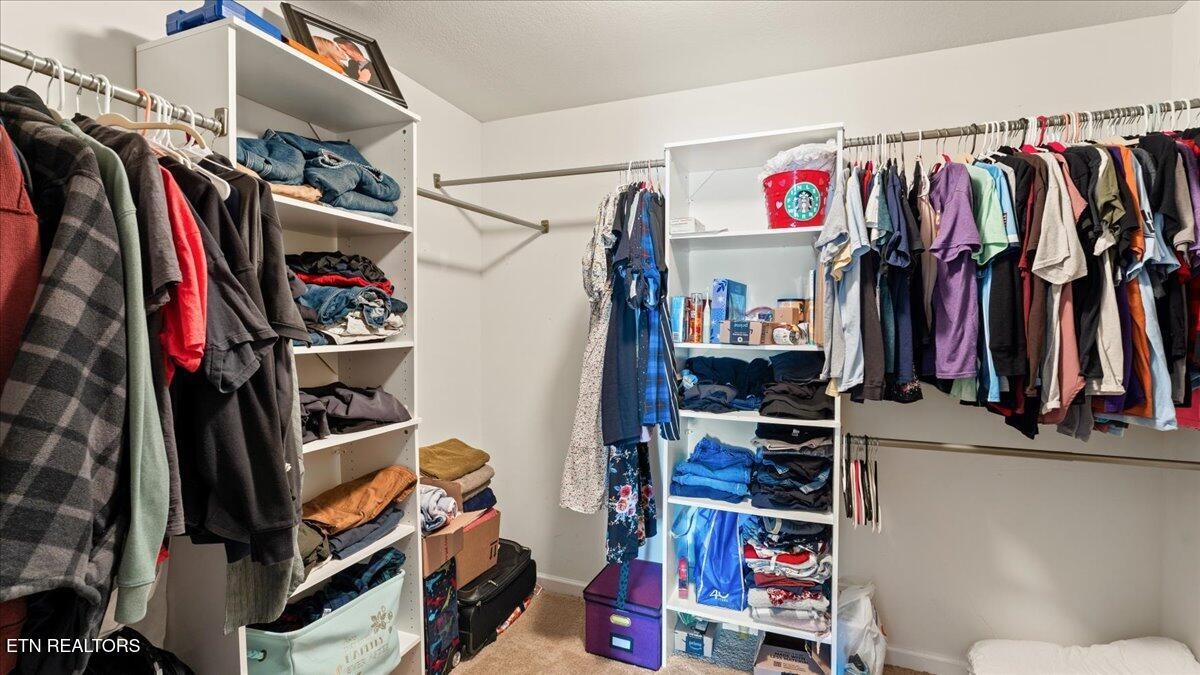 1816 River Poppy Road Mascot, TN 37806 - Photo 33 of 52 a view of walk in closet with clothes and shoes