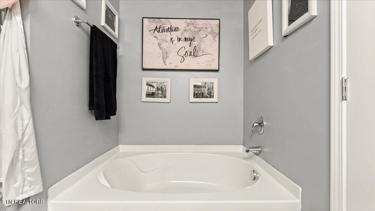 1816 River Poppy Road Mascot, TN 37806 - Photo 34 of 52 a white bath tub sitting in a bathroom