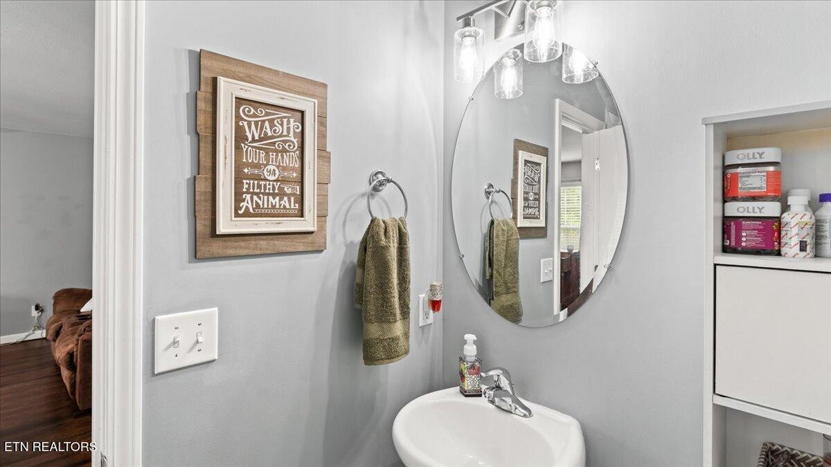 1816 River Poppy Road Mascot, TN 37806 - Photo 5 of 52 a bathroom with a sink mirror and vanity
