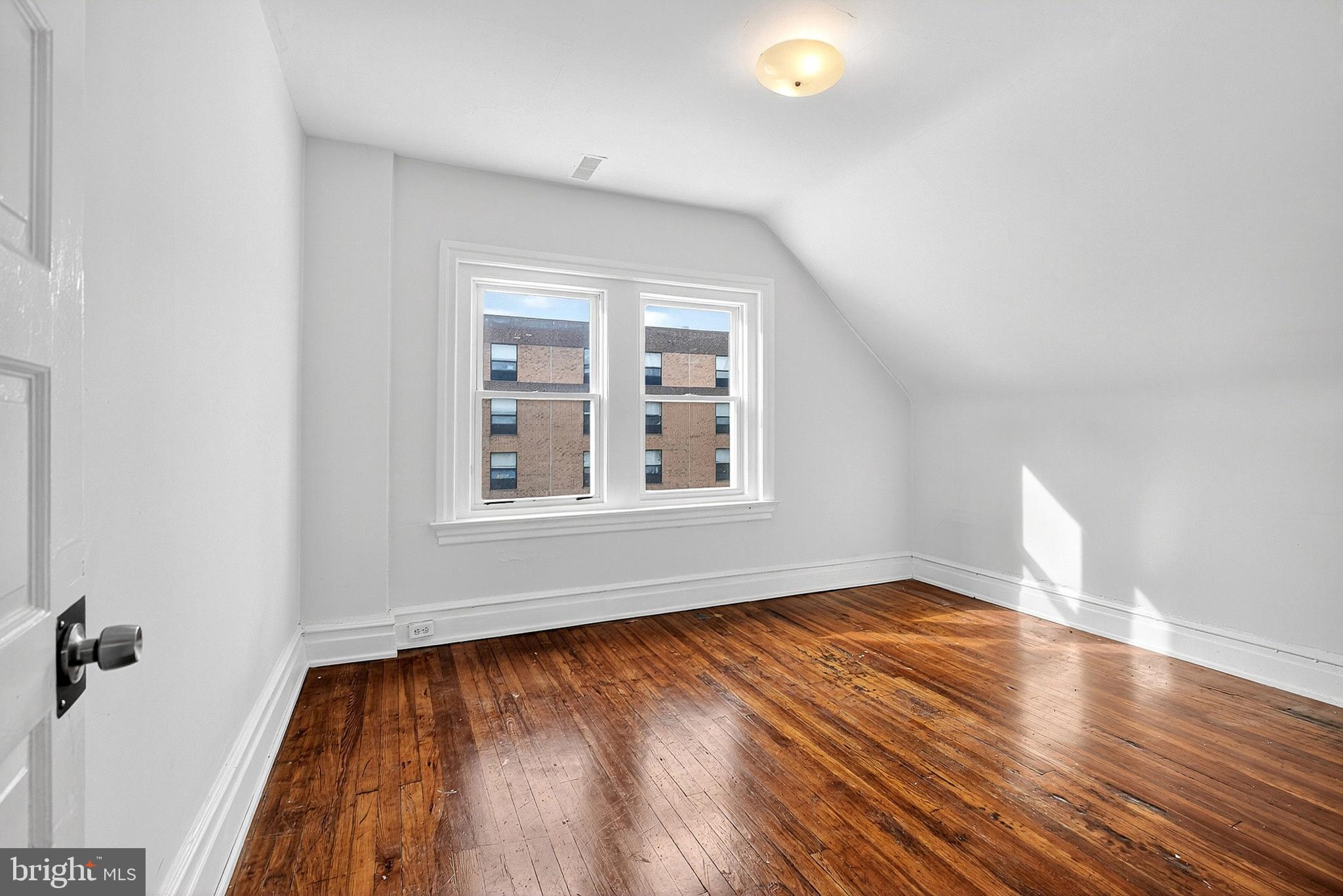 5506 Greene Street Philadelphia, PA 19144 - Photo 11 of 17 an empty room with wooden floor and windows