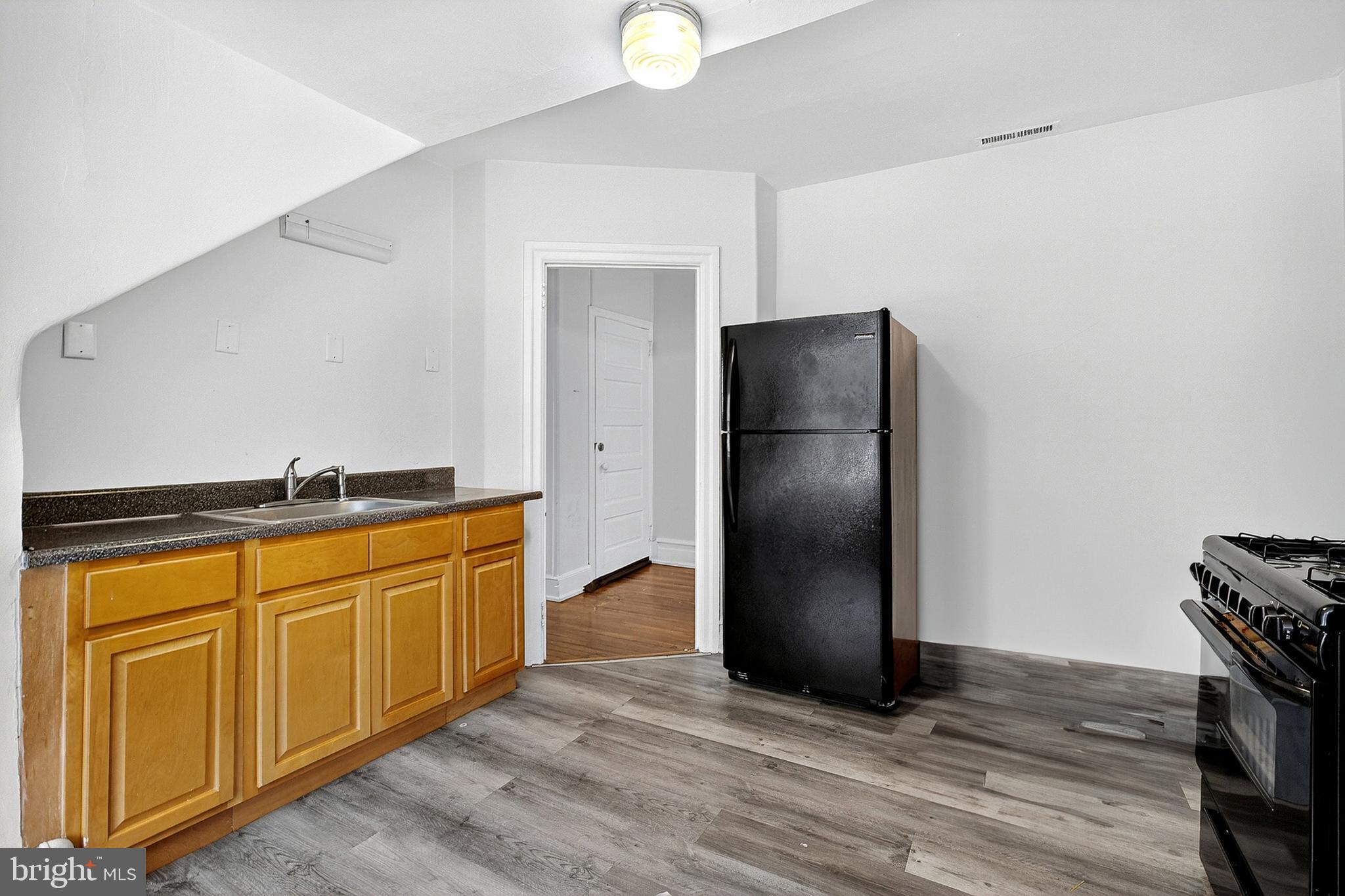 5506 Greene Street Philadelphia, PA 19144 - Photo 13 of 17 a kitchen with stainless steel appliances granite countertop a refrigerator and a sink