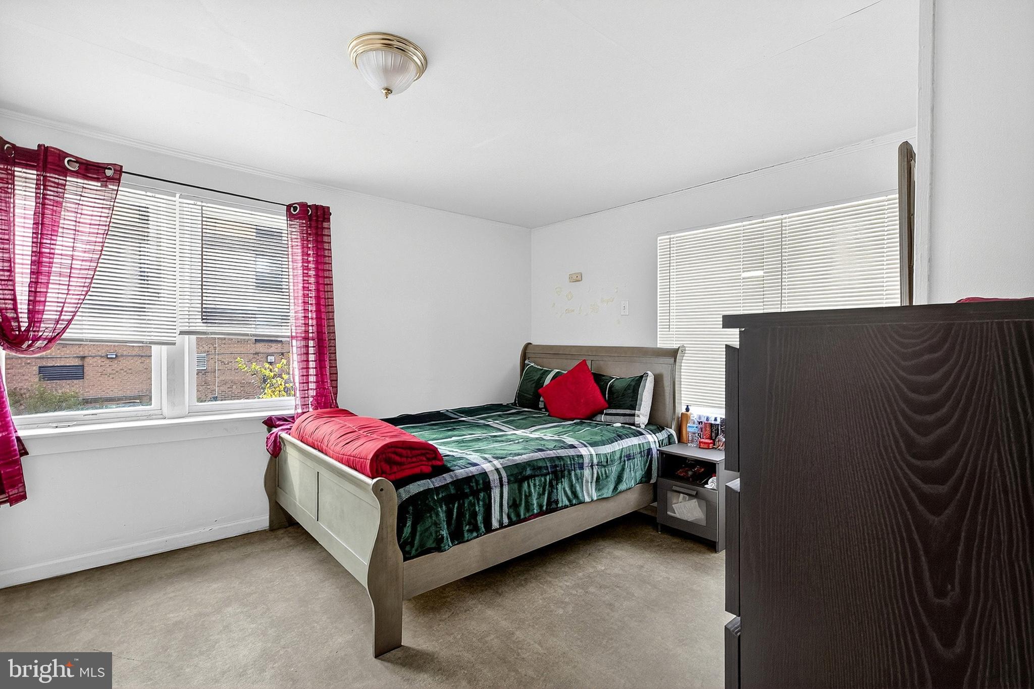 5506 Greene Street Philadelphia, PA 19144 - Photo 8 of 17 a bedroom with a bed closet and window