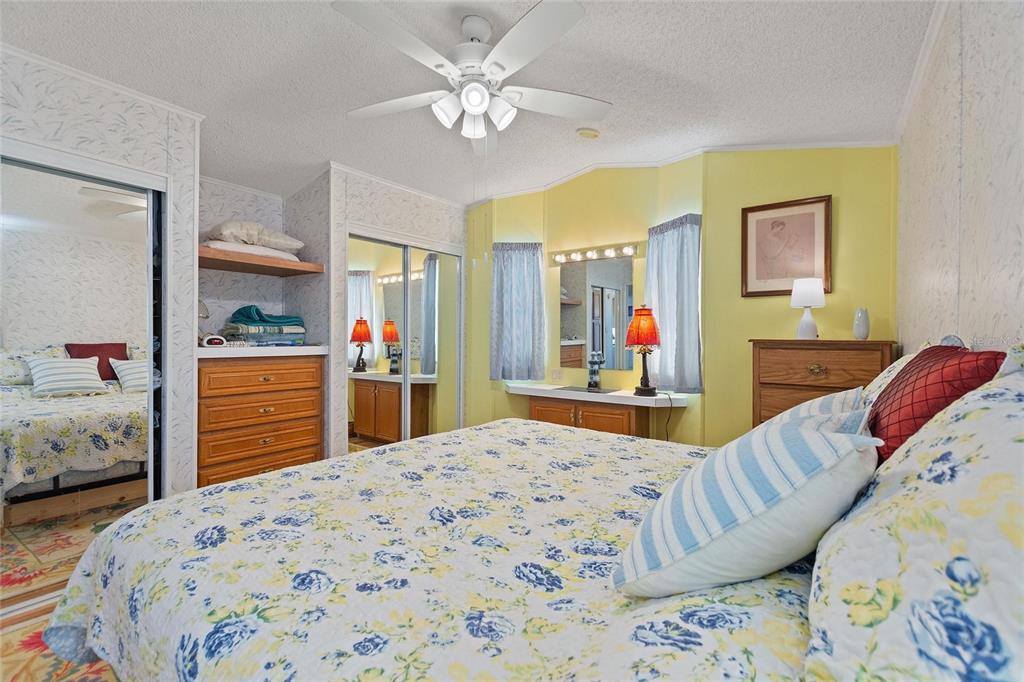 251 Patterson Road, Unit J19 Haines City, FL 33844 - Photo 15 of 30 a bedroom with a bed a dresser and painting on the dresser