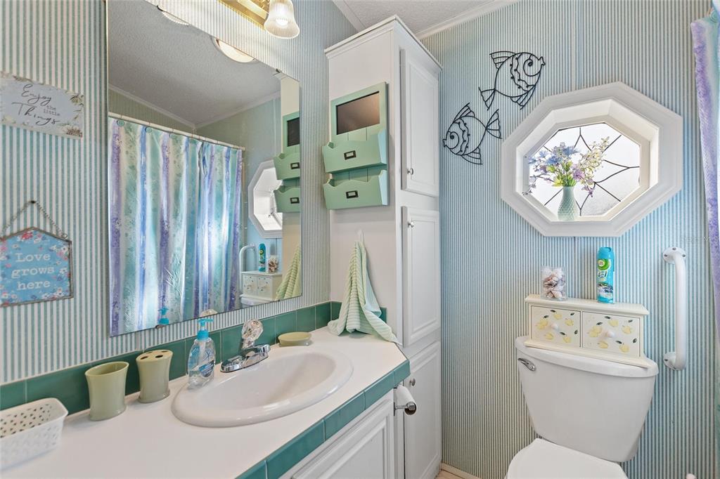 251 Patterson Road, Unit J19 Haines City, FL 33844 - Photo 16 of 30 a bathroom with a sink vanity mirror and toilet