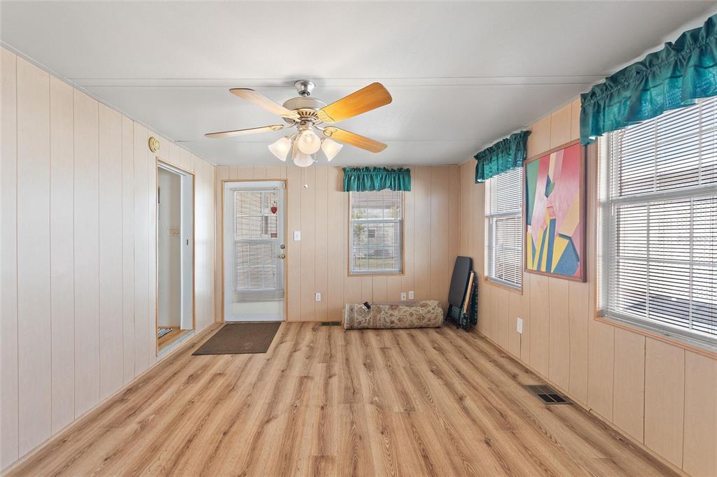 251 Patterson Road, Unit J19 Haines City, FL 33844 - Photo 18 of 30 a view of a bedroom with wooden floor and a window