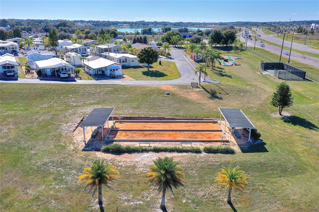 251 Patterson Road, Unit J19 Haines City, FL 33844 - Photo 29 of 30 a view of a swimming pool with lawn chairs