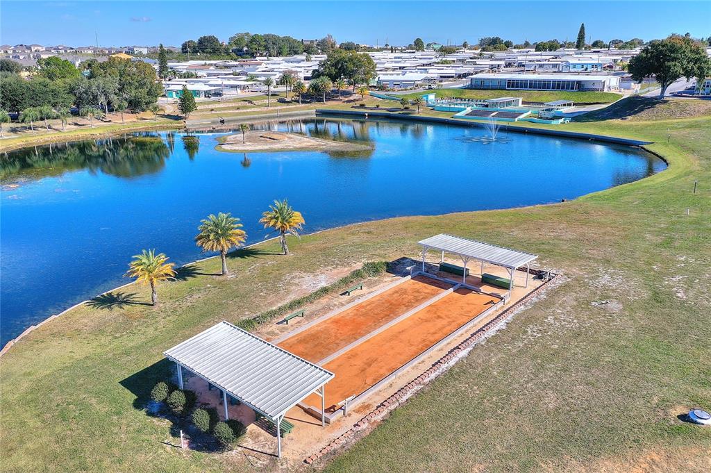 251 Patterson Road, Unit J19 Haines City, FL 33844 - Photo 30 of 30 swimming pool with outdoor seating and lake view