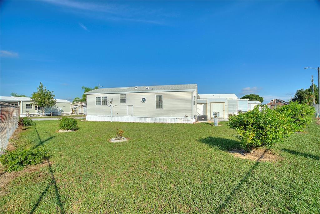 251 Patterson Road, Unit J19 Haines City, FL 33844 - Photo 6 of 30 a view of pool with lawn chairs and plants