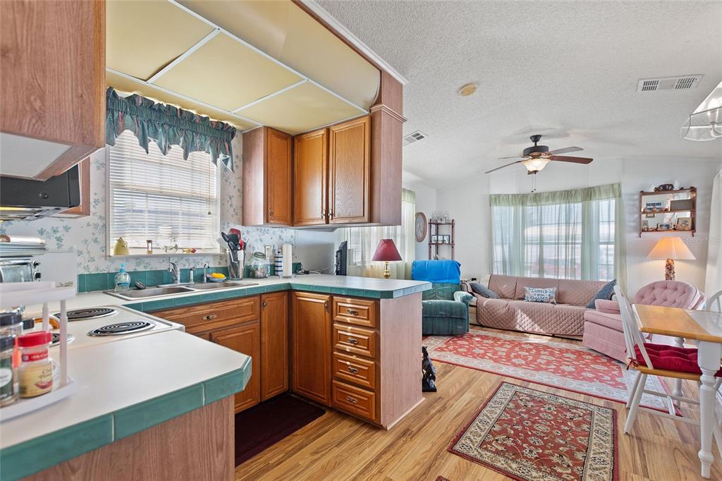 251 Patterson Road, Unit J19 Haines City, FL 33844 - Photo 9 of 30 a kitchen that has a sink and a stove in it