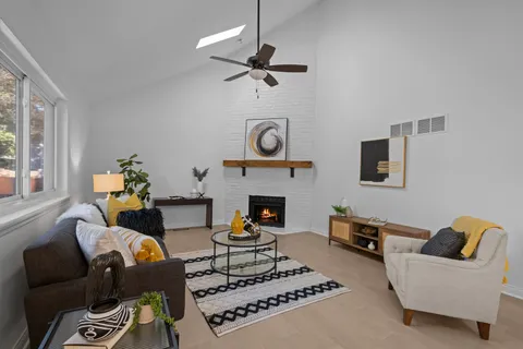 a living room with furniture and a fireplace