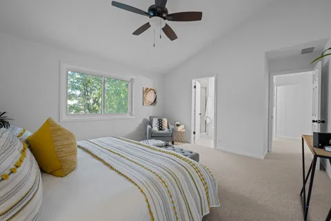 a bedroom with a bed and ceiling fan
