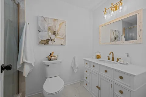 a white toilet sitting next to a bathroom sink