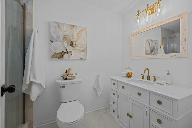 a white toilet sitting next to a bathroom sink