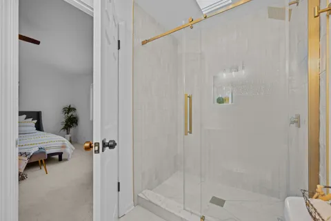 a view of a bathroom shower and a tub