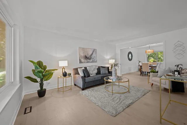 a living room with furniture a chandelier and a window