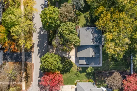 an aerial view of a house with a yard