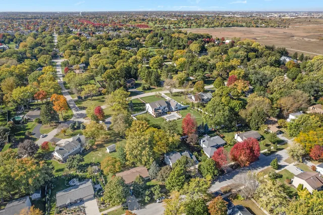 an aerial view of a houses with a yard