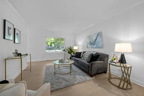 a living room with furniture a window and a lamp