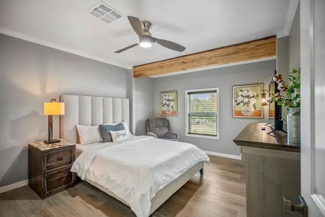 a bedroom with a bed and wooden floor