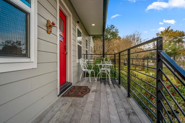a view of balcony with chairs and wooden fence