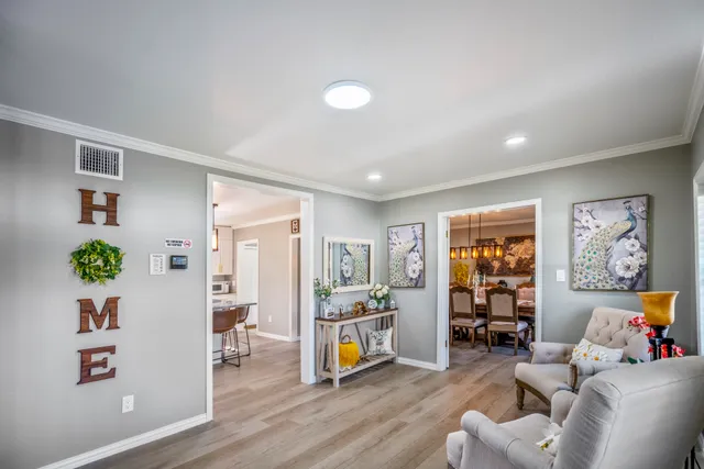 a living room with furniture and a wooden floor