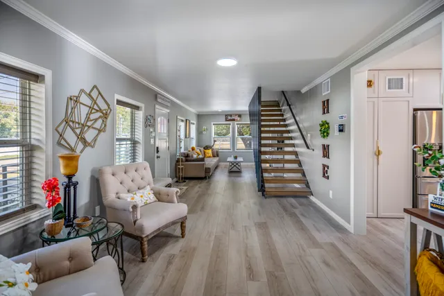 a living room with furniture and a wooden floor