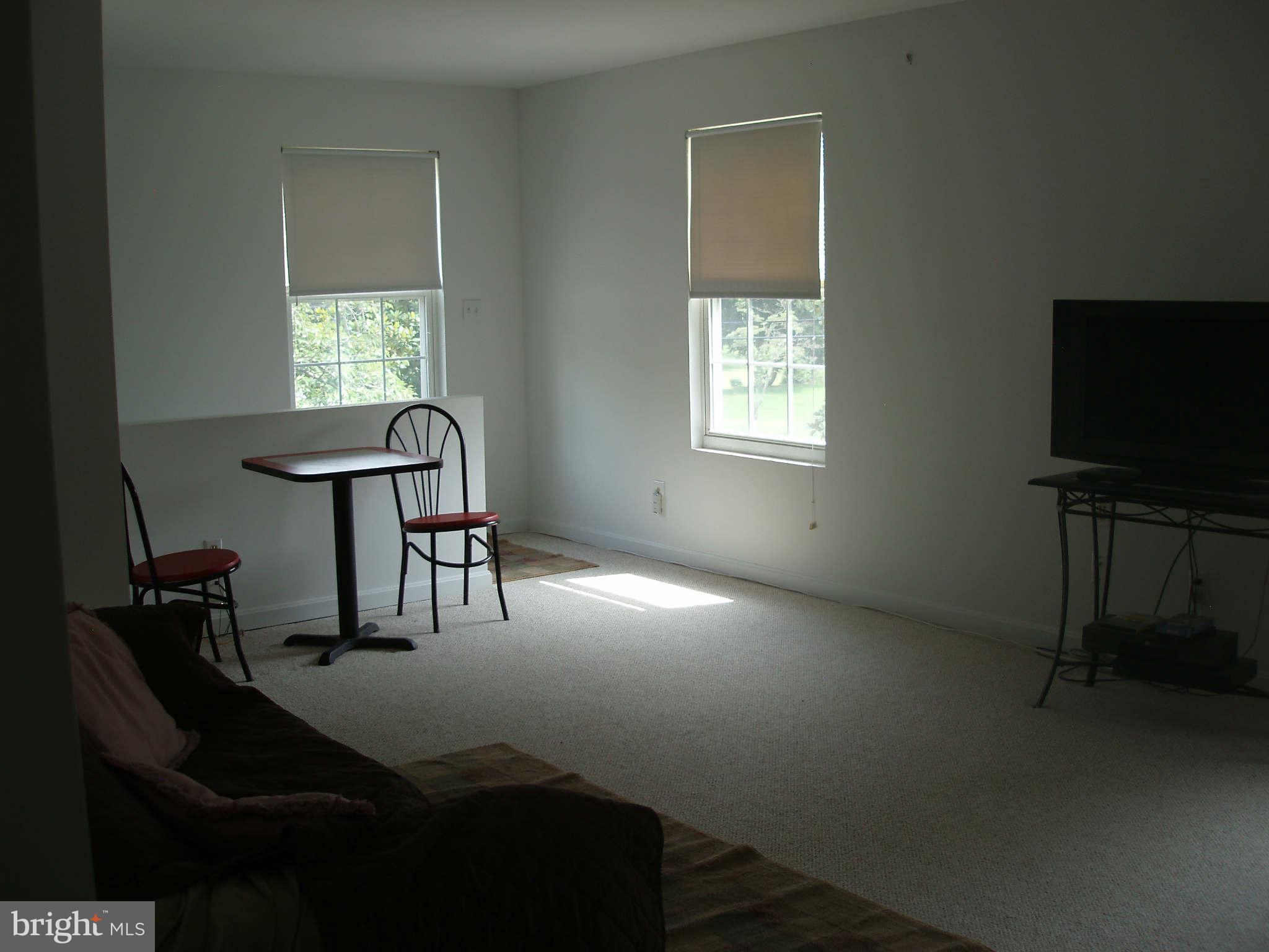200 Cox Road Huntingtown, MD 20639 - Photo 12 of 27 a view of a workspace with furniture and a window