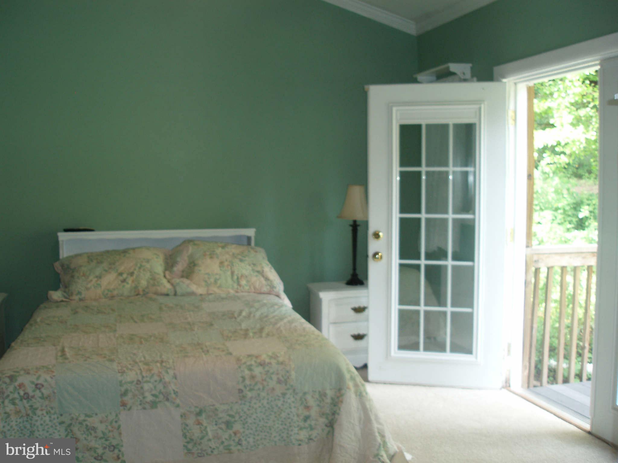 200 Cox Road Huntingtown, MD 20639 - Photo 13 of 27 a large bed sitting in a bedroom next to a window