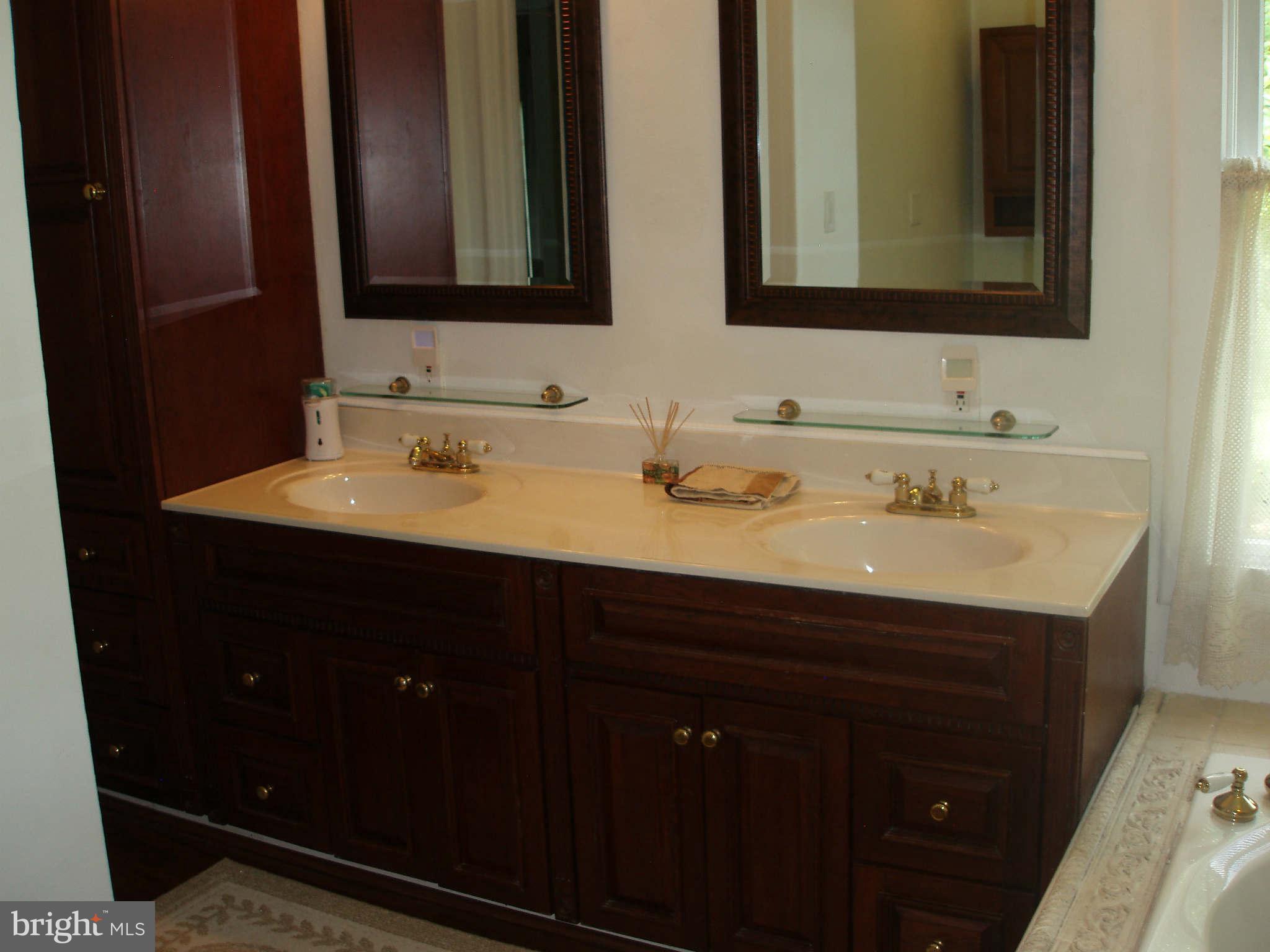 200 Cox Road Huntingtown, MD 20639 - Photo 15 of 27 a bathroom with a double vanity sink and large mirror