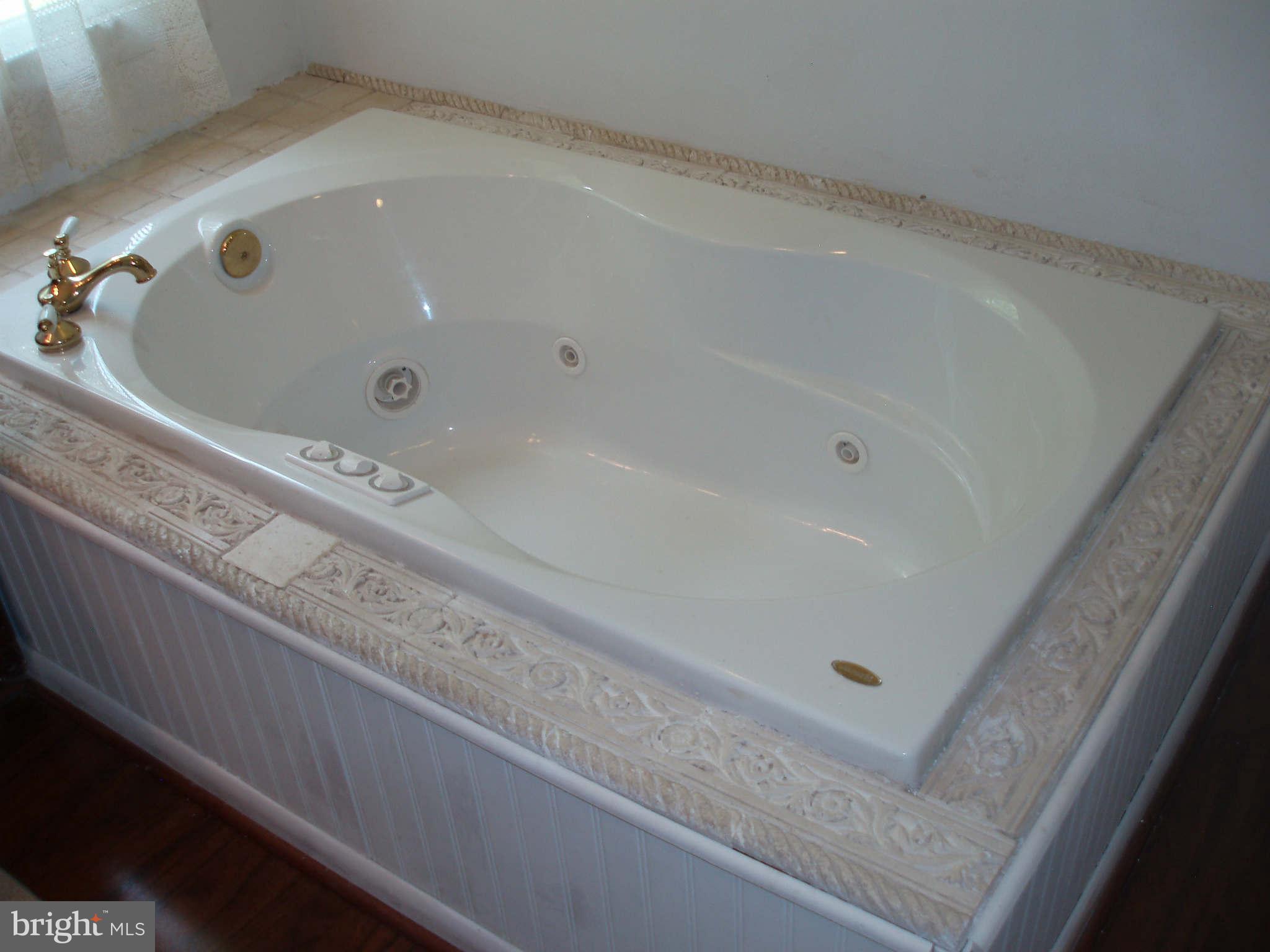 200 Cox Road Huntingtown, MD 20639 - Photo 16 of 27 a bathroom with a tub and a sink