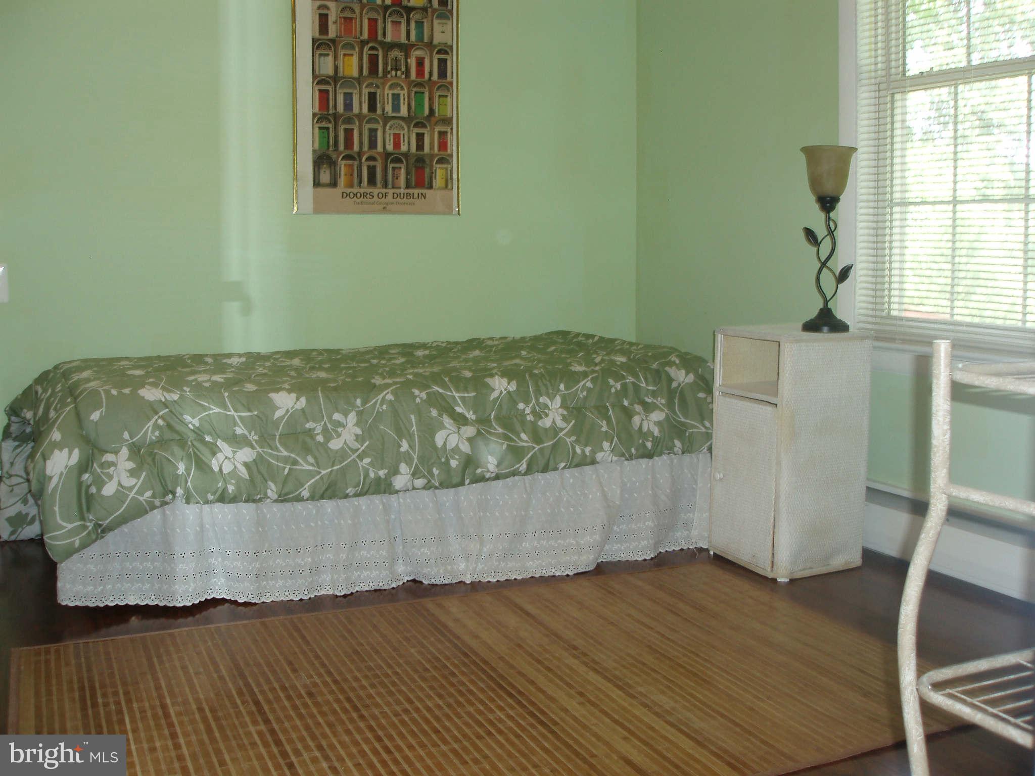 200 Cox Road Huntingtown, MD 20639 - Photo 19 of 27 an empty room with wooden floor and windows