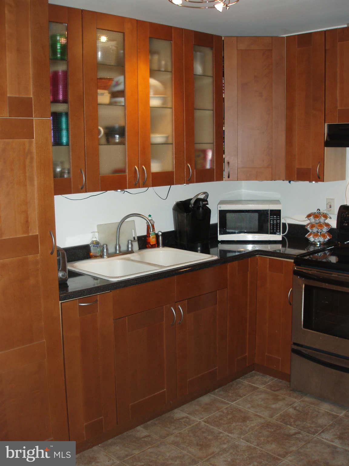 200 Cox Road Huntingtown, MD 20639 - Photo 23 of 27 a kitchen with stainless steel appliances granite countertop a sink stove and refrigerator