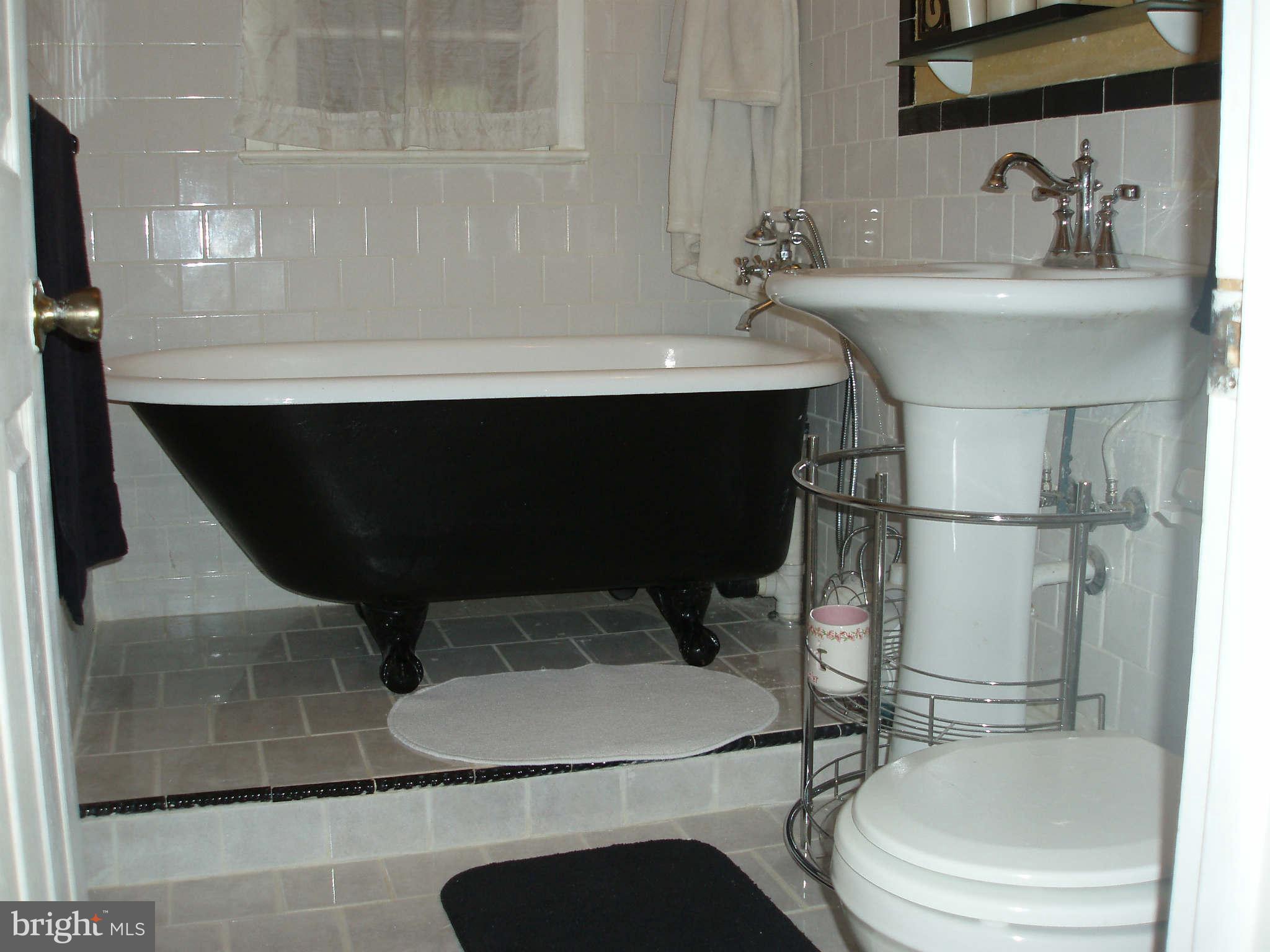 200 Cox Road Huntingtown, MD 20639 - Photo 7 of 27 a bathroom with a sink toilet and shower