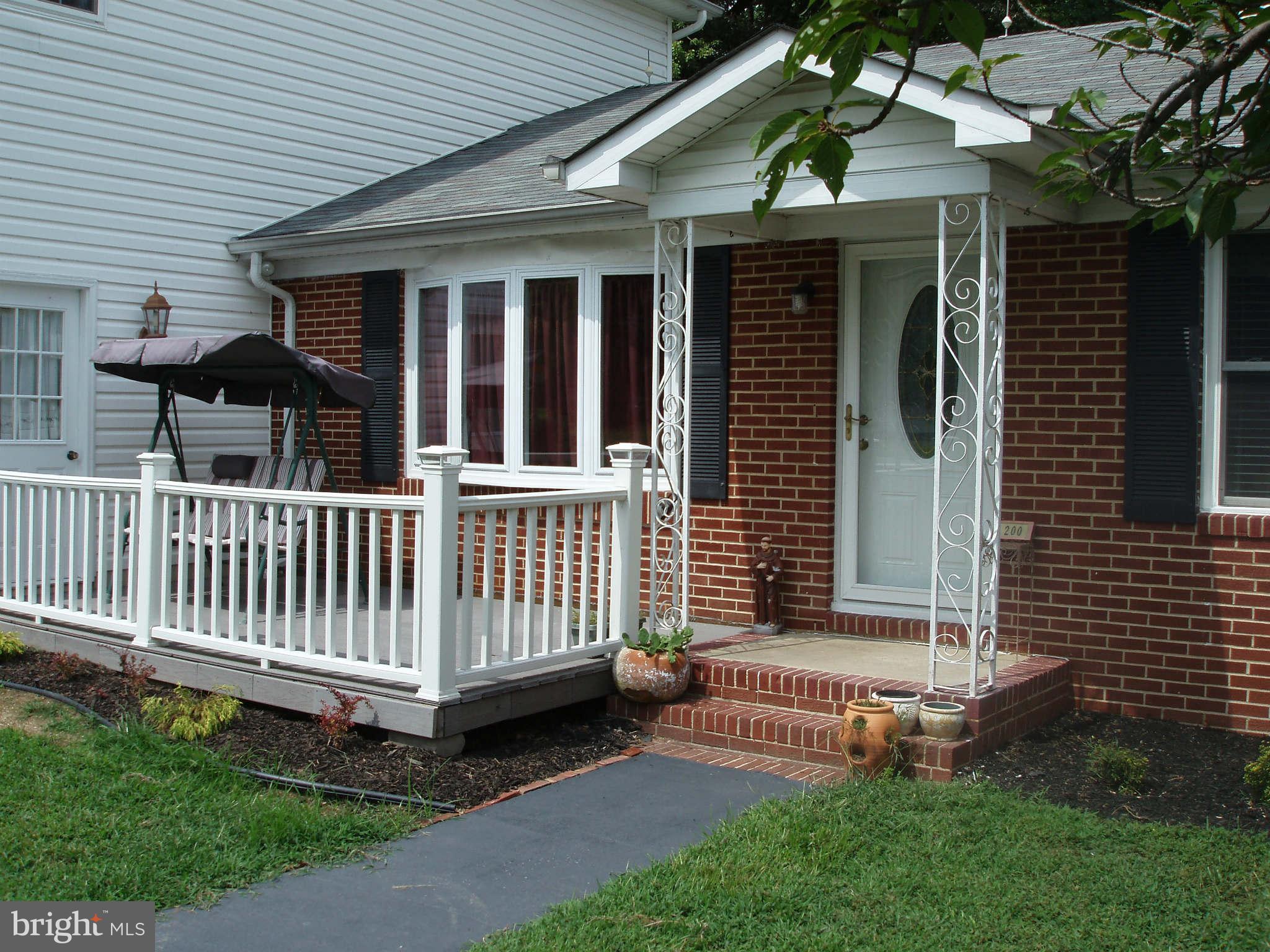 200 Cox Road Huntingtown, MD 20639 - Photo 8 of 27 a front view of a house with a garden