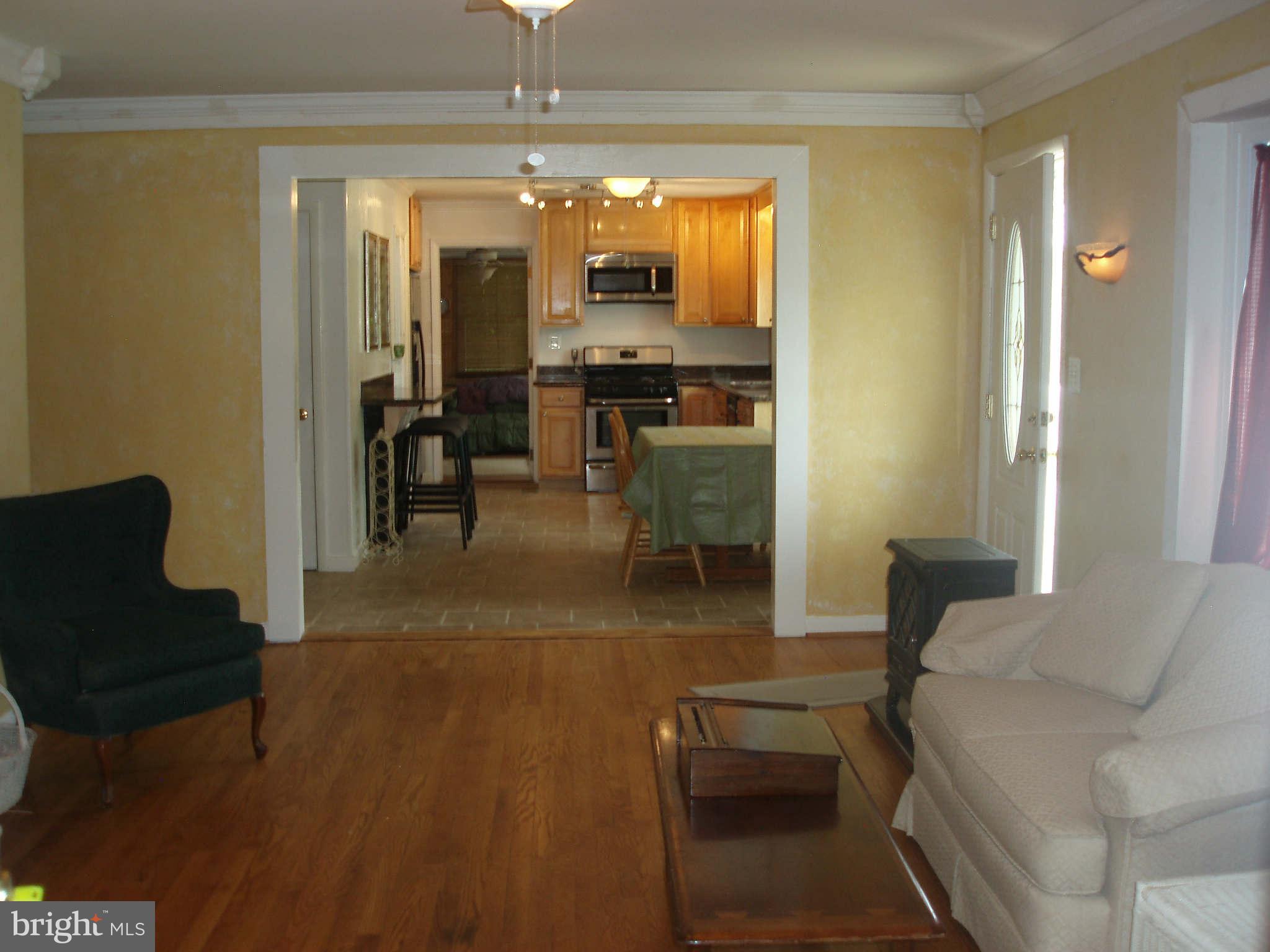 200 Cox Road Huntingtown, MD 20639 - Photo 10 of 27 a living room with furniture and a chandelier