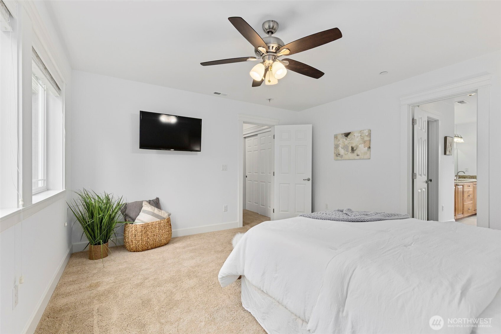 7650 Northeast 204th Place Kenmore, WA 98028 - Photo 20 of 39 a bedroom with a large bed and a flat screen tv