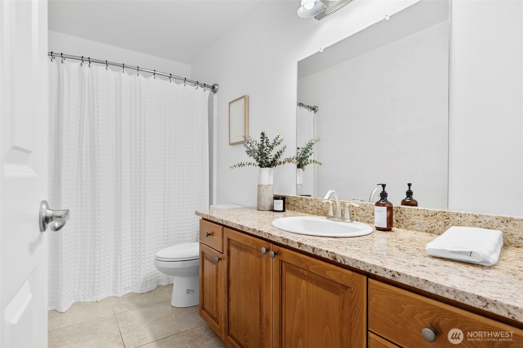 7650 Northeast 204th Place Kenmore, WA 98028 - Photo 31 of 39 a bathroom with a granite countertop sink and a mirror with toilet