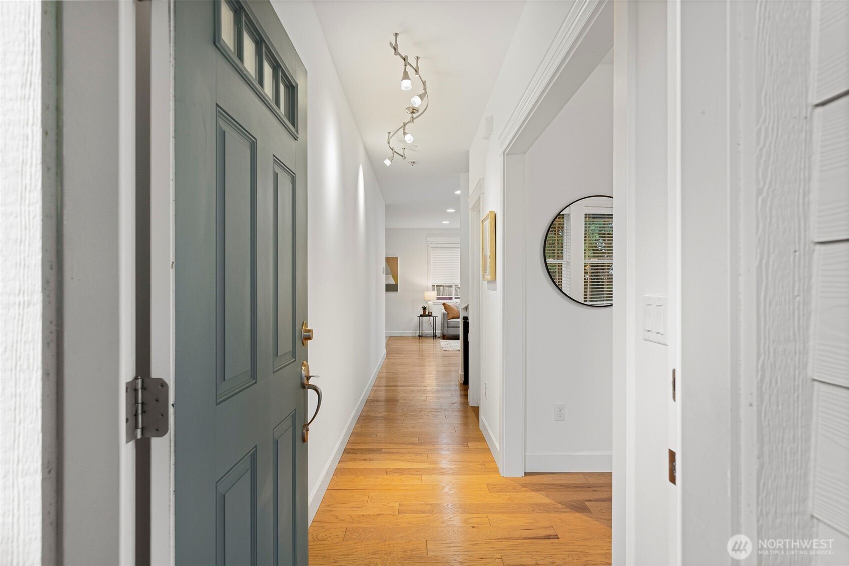 7650 Northeast 204th Place Kenmore, WA 98028 - Photo 5 of 39 a view of a hallway with wooden floor and a chandelier