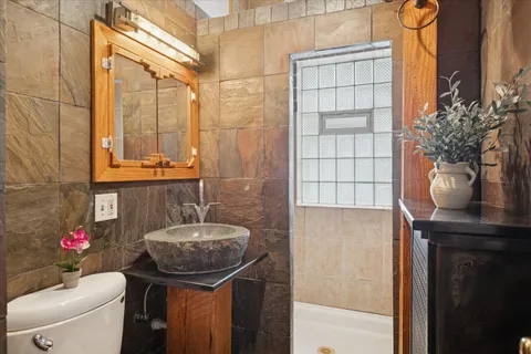 a bathroom with a sink a toilet and shower curtain