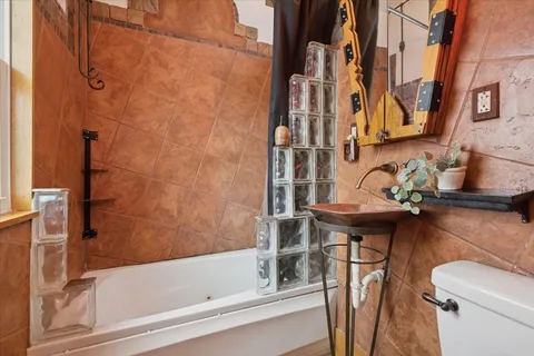 a bathroom with a sink toilet and shower