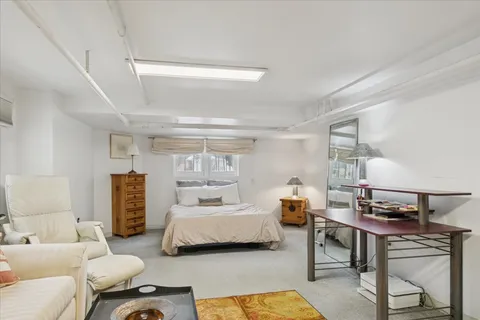 a bedroom with furniture and a wooden floor