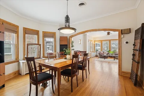 a view of a dining room with furniture window and wooden floor