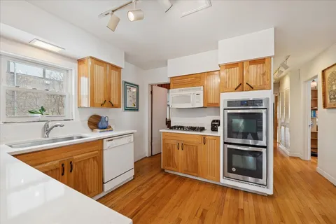 a kitchen with stainless steel appliances granite countertop a stove a sink and a refrigerator
