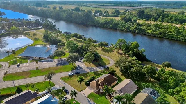 an aerial view of a house with garden space and lake view
