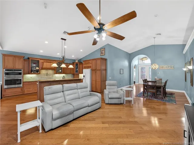 a living room with furniture a window and a flat screen tv