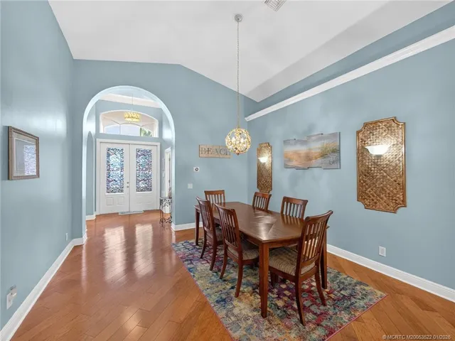 a living room with furniture a floor to ceiling window and a flat screen tv