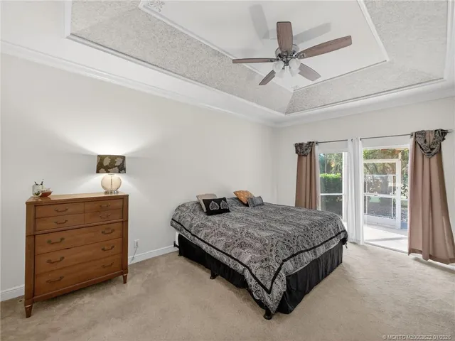 a bedroom with a bed and ceiling chandelier